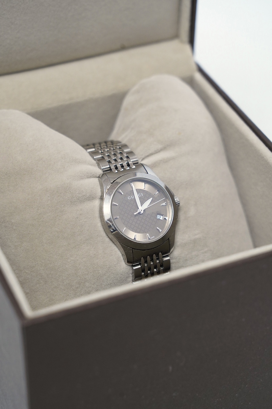 A lady's modern stainless Gucci quartz wrist watch, with date aperture, box and booklet. Condition - fair